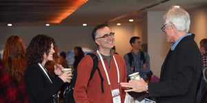 Peter Kelly-Detwiler talking to someone at the Summit