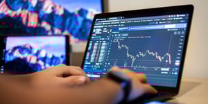 man typing on a computer with data